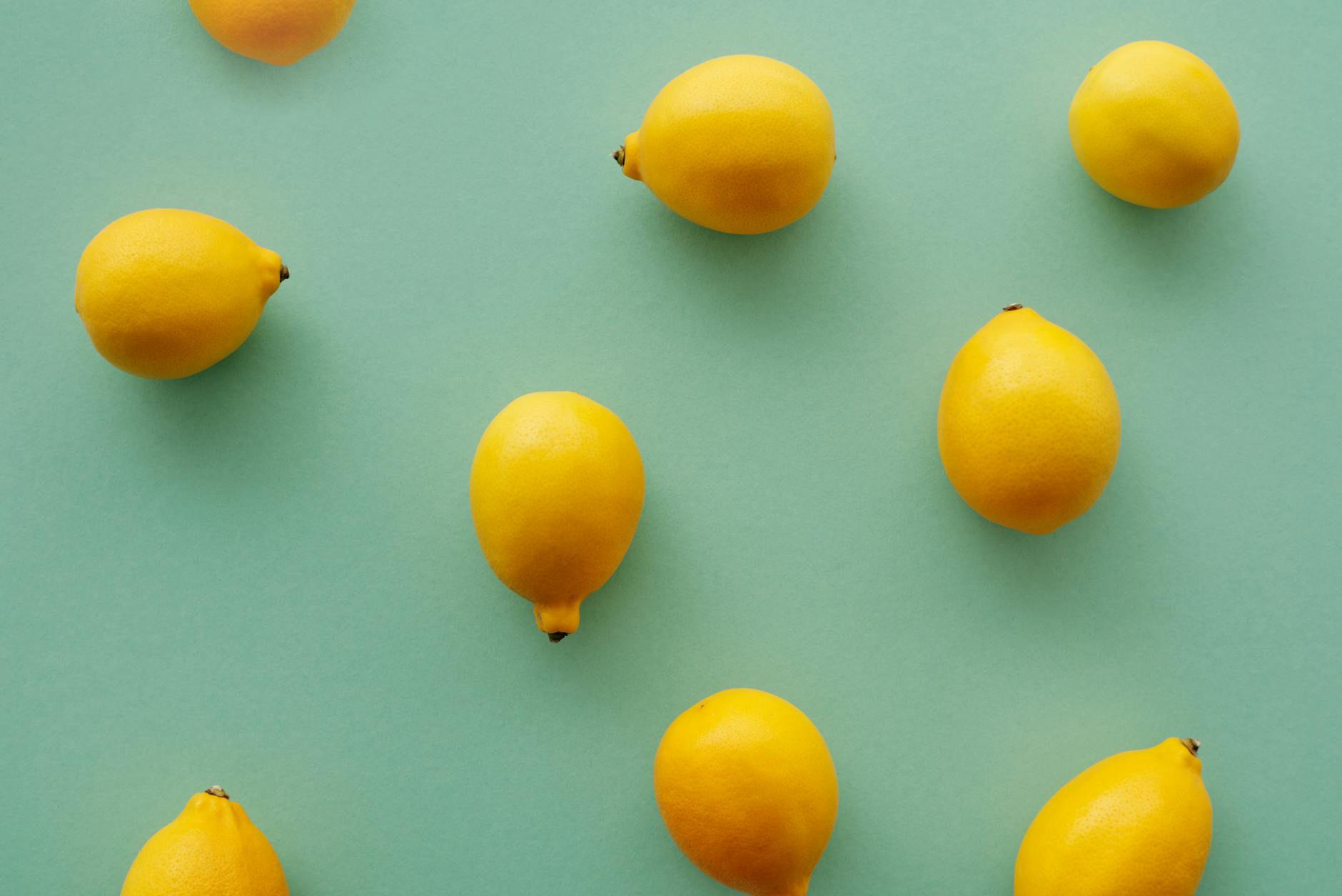 Fresh bright lemons on a soft pastel background, symbolizing renewal and natural arousal restoration.