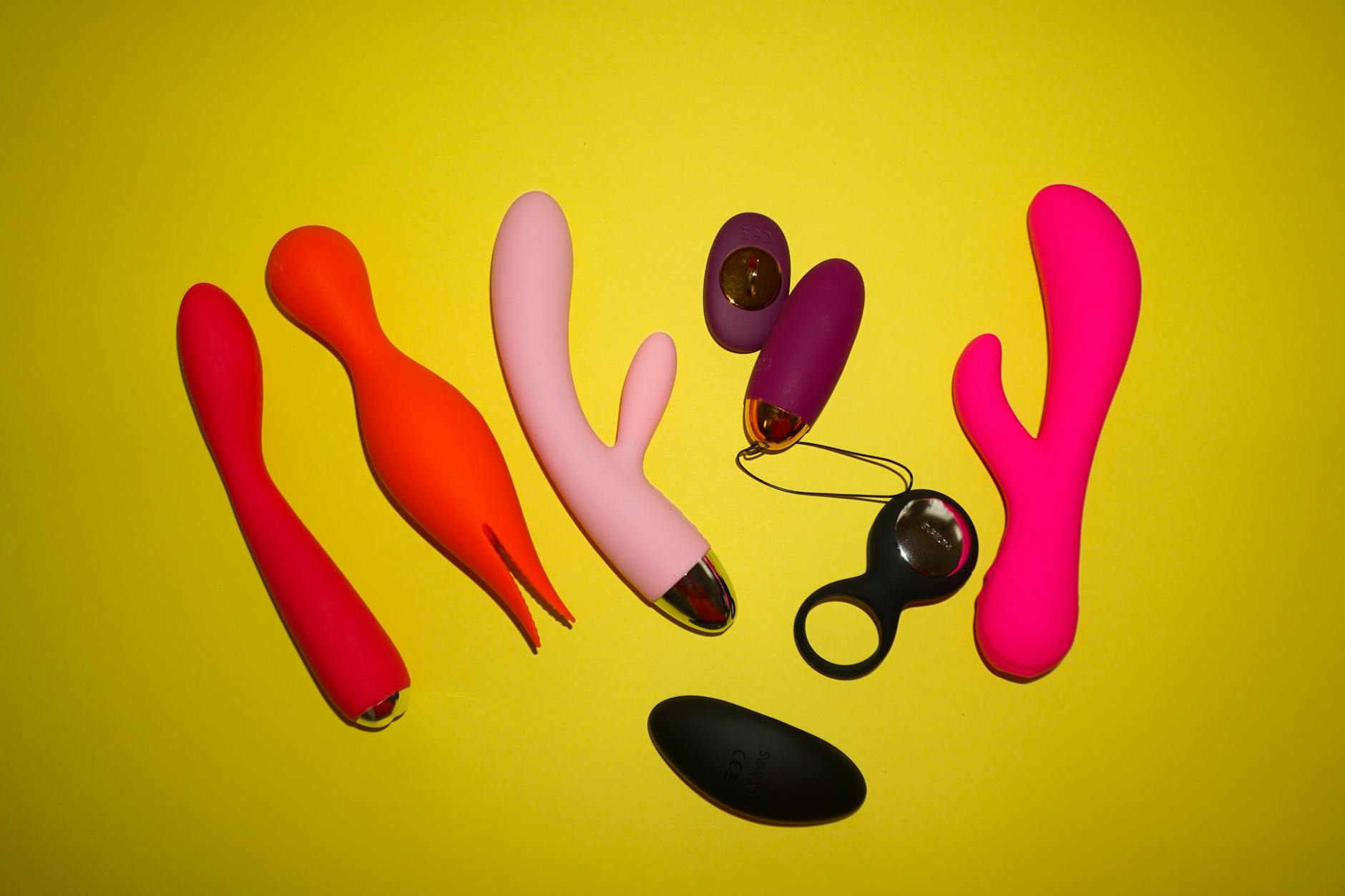 Woman holding lemon clitoral vibrators, considering pleasure and intimacy